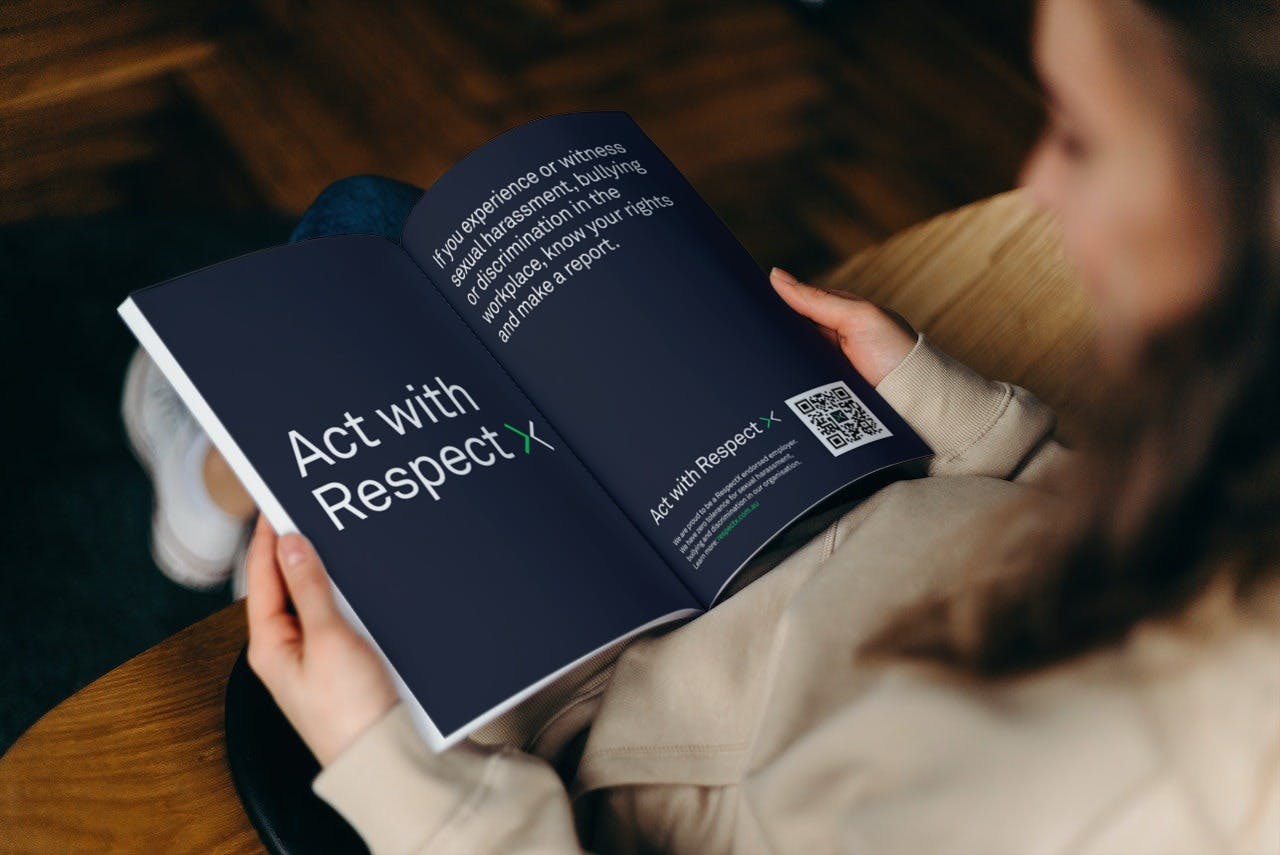 A photo of a person reading a magazine with a double page advertisement for RespectX